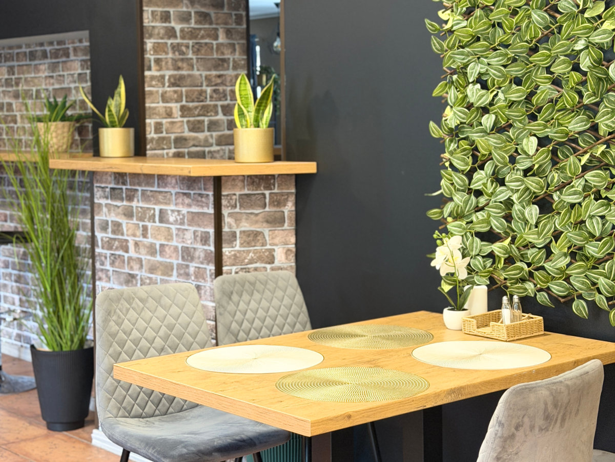 Dining table beside the plant wall at Asian Wok Paldiski